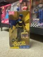 2003 Mattel DC Comics Batgirl Barbie doll featuring a blue cape and yellow acces
