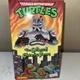 NECA Teenage Mutant Ninja Turtles: The Colossal Chrome Dome Action Figure...