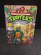1991 TMNT Michaelangelo with Storage Shell Unpunched Playmates New Sealed Card